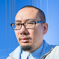Color headshot image of author Bao Phi with blue background